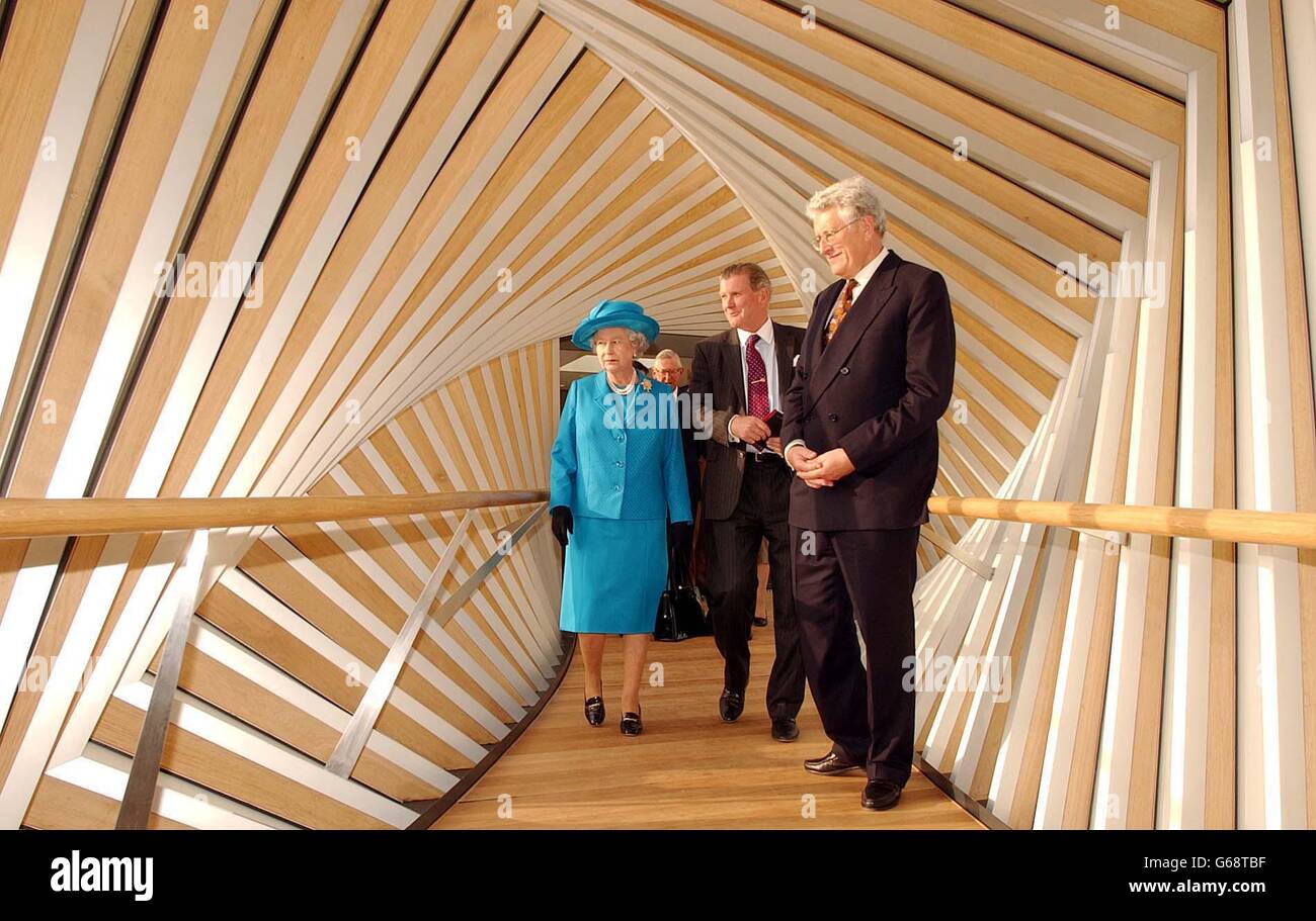 Britain's Queen Elizabeth II, with David Norman (centre) Chairman of the Royal ballet school, and Sir Colin Southgate Chairman of the Royal Opera House cross the 'Bridge of Aspiration' which links the Ballet school to the Royal Opera house, after she toured the newly built Royal Ballet School, which she officially opened in Covent garden. Stock Photo