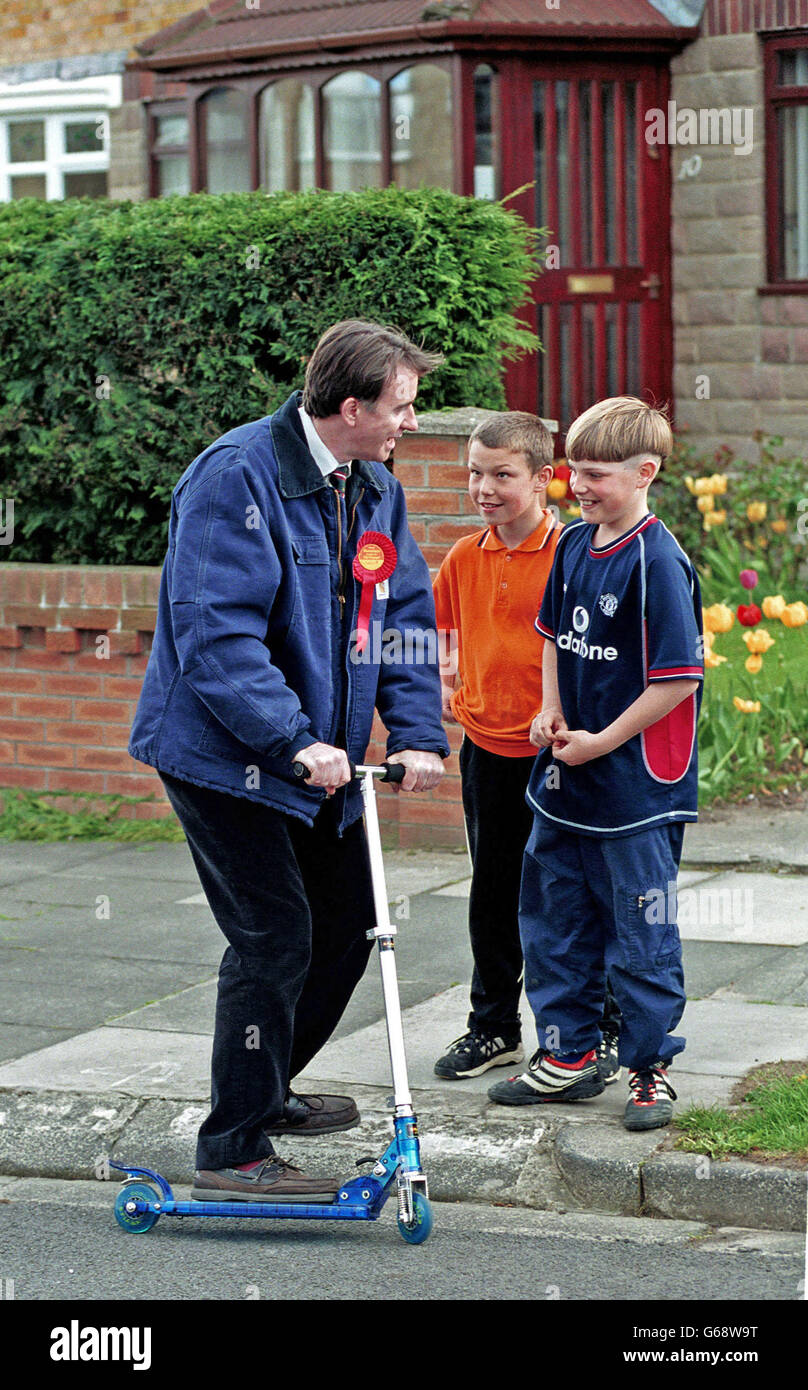 Peter Mandleson MP right canvasing from door to door in his constituency of Hartlepool in County Durham, N E England, for the British 2001 general election. He later became European Commissioner for Trade (2004 and 2008) and was made a life peer. Peter Mandleson tries out a mini scooter borrowed for a moment from to passing children. Stock Photo