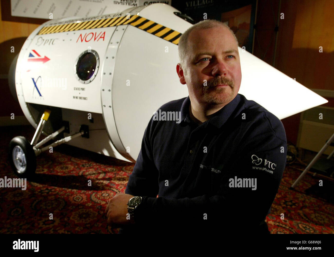 Amateur rocket enthusiast Steve Bennett, 39, from Duckinfield, Greater Manchester, who is hoping to become the first amateur to fly in space in a privately developed craft, sits next to the new Nova II rocket capsule at its launch in Manchester. *...His Starchaser firm today unveiled the single seater capsule, which is being readied for shipment to the US, where it is to be fitted with a parachute system before being tested. *160703*Amateur rocket enthusiast Steve Bennett, 39, from Duckinfield, Greater Manchester. The rocket enthusiast is hoping to become the first amateur to fly into space Stock Photo