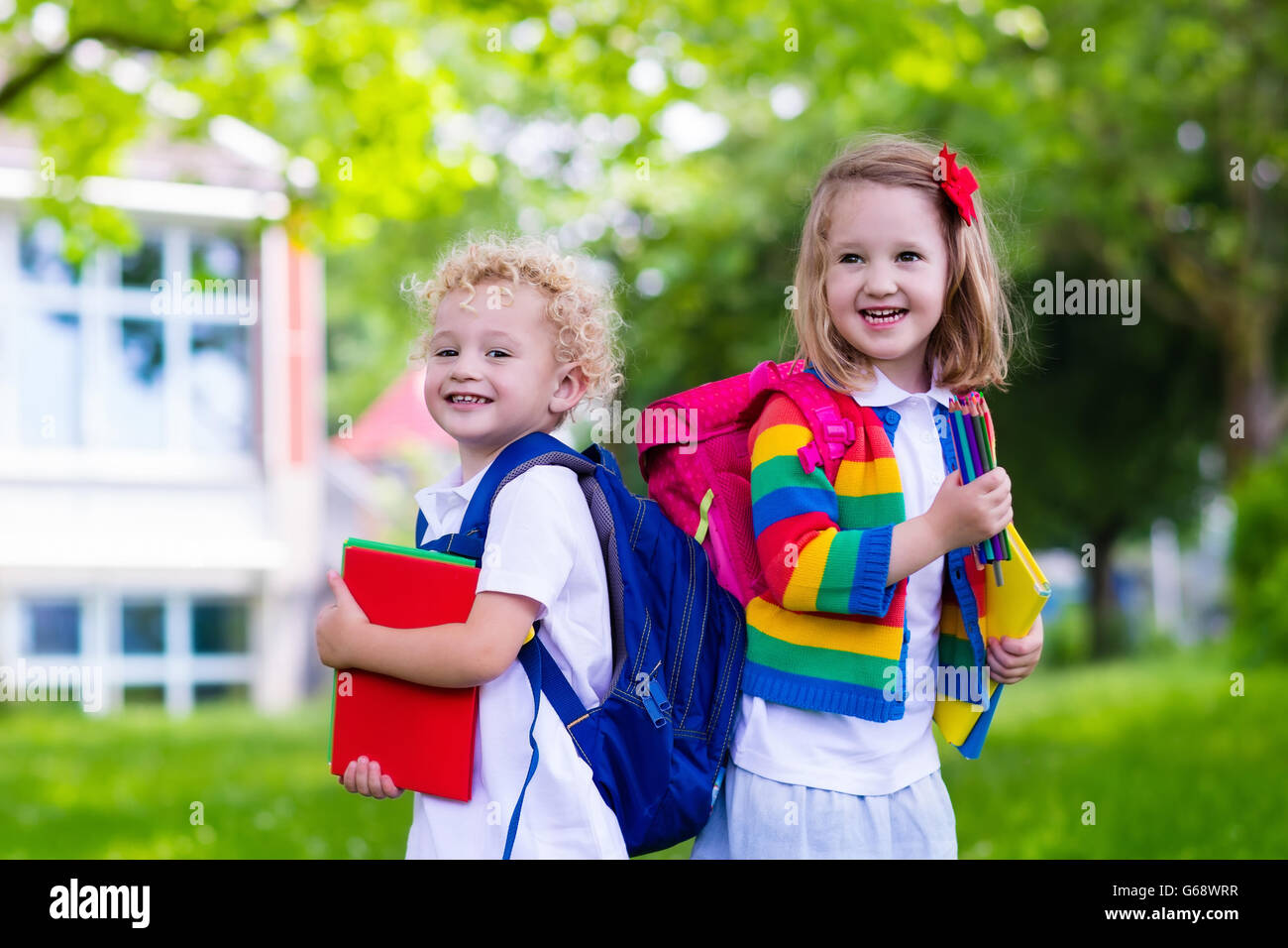 Child going to school. Boy and girl holding books and pencils on first ...