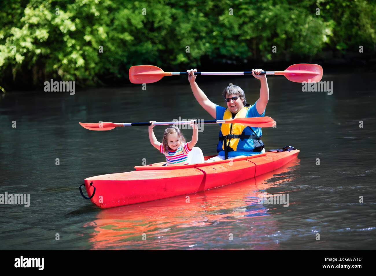 Family on kayaks and canoe tour. Mother and child paddling in kayak in a  river on a sunny day. Children in summer sport camp Stock Photo - Alamy