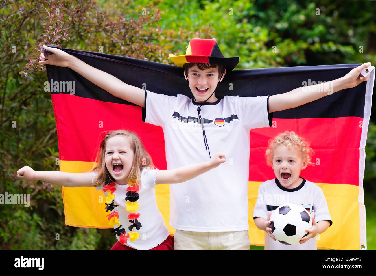 Children cheering and supporting German national football team. Kids