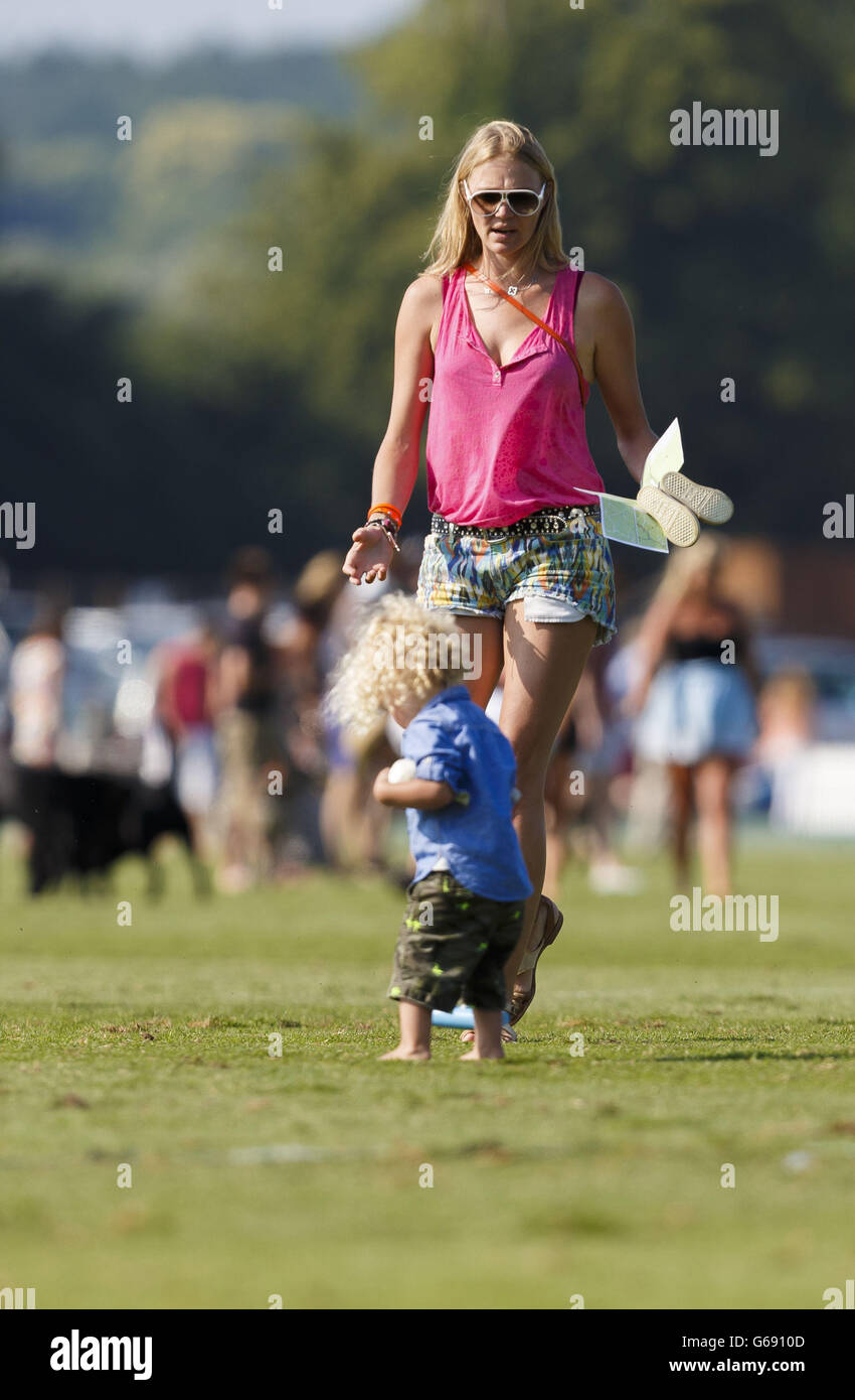Super model Jodie Kidd and her son Indio help tread-in the divots on the  pitch during a break the second semi-final of the Veuve Clicquot Polo Gold  Cup at Cowdray Park in