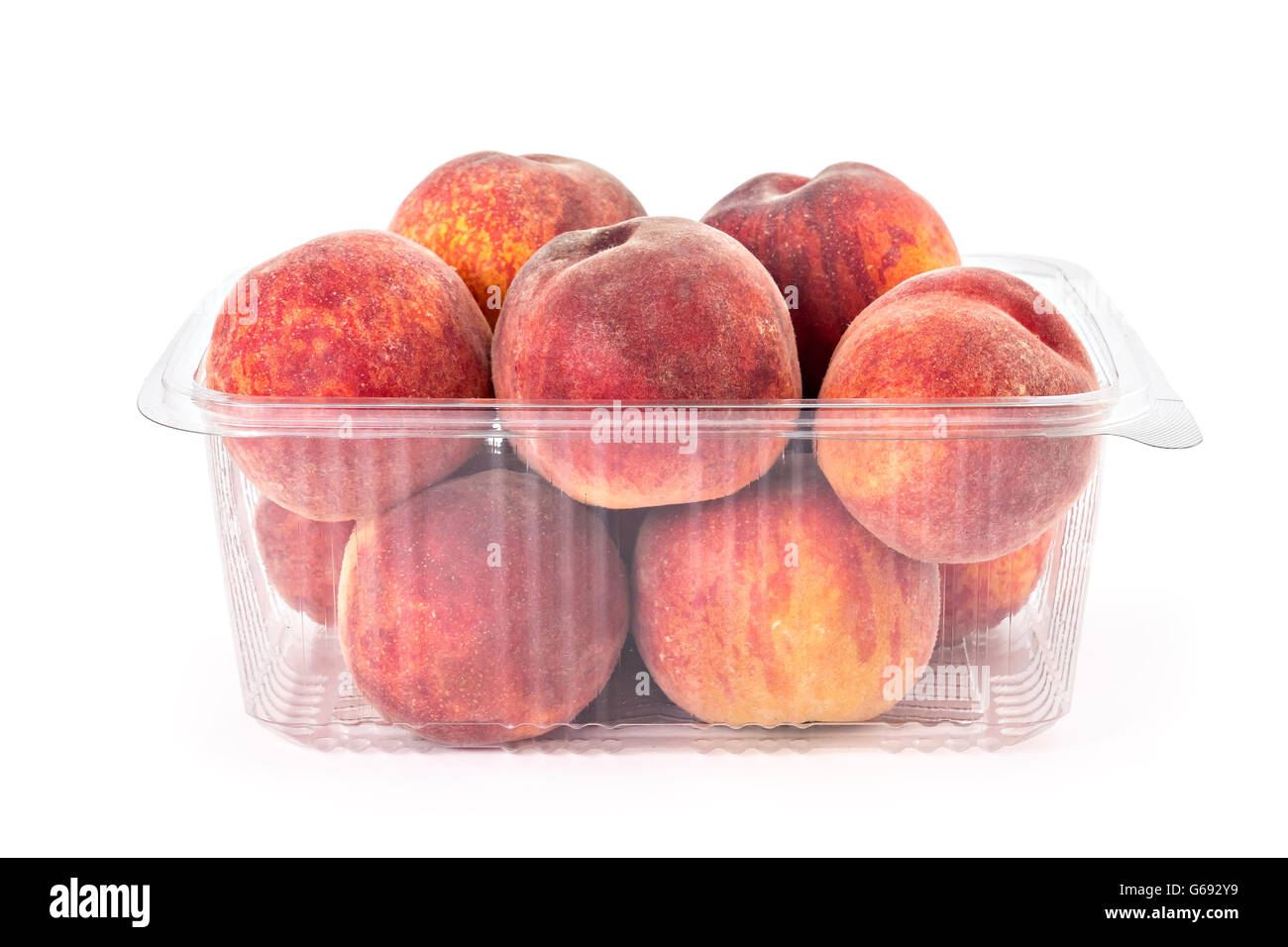 Box or of fresh ripe organic peaches isolated on white