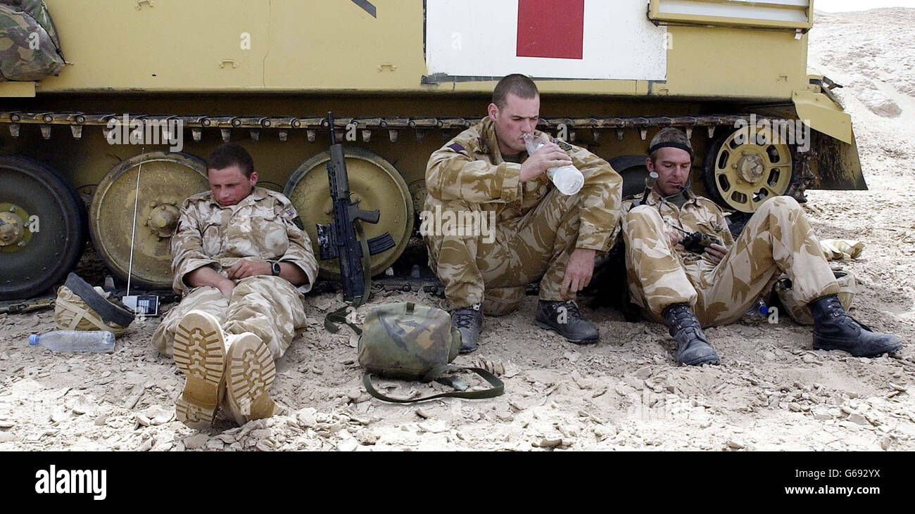 Soldiers from the Household Cavalry relax by their spartan tank,while American forces are sent further into Iraq. Stock Photo