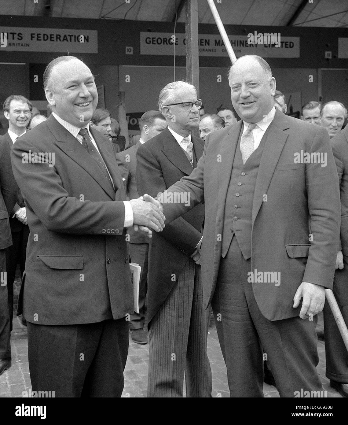 Dr Richard Beeching, (right) woh will soon be leaving his post as Chairman of the british Railways Board, has his hand shaken by Lord Robens, Chairman of the Natinla coal Board and thanked for his service to the railways at Marlybone, London. The occasion was the opening of the Second Coal Handling Exhibition. Stock Photo
