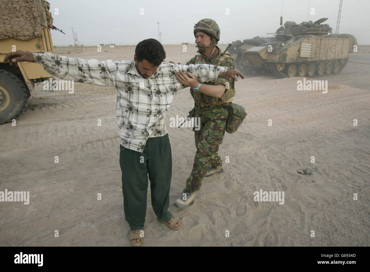 British soldier searches Iraqi Stock Photo