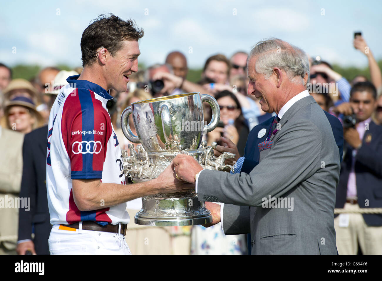 The Prince of Wales presents England captain Luke Tomlinson with the winners' trophy Audi International Polo featuring the Westchester Cup, at Guards Polo Club in Egham, Surrey. Stock Photo