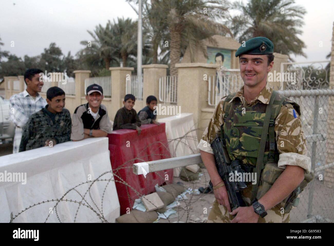 Royal Marine Gary Webster, serving with 45 Commando Zulu Company, at the gate of their billet in Umm Qsar in Southern Iraq. Stock Photo