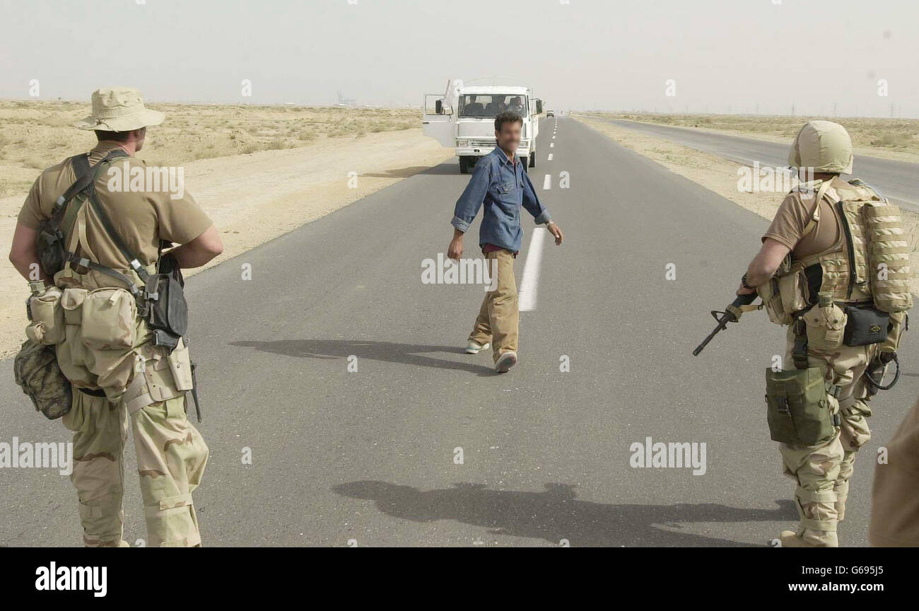 An Iraqi with a white flag on his truck ready to hand himself to American soldiers as ordered on the main road from Umm Qasr to Basra, just noth of the port. Stock Photo