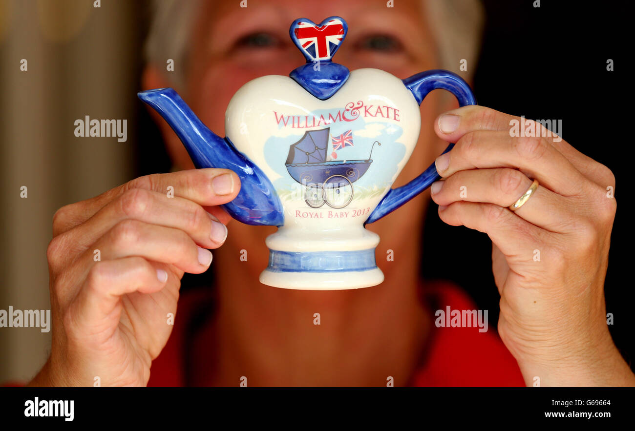 Carol Bridger, of Tony Carter Ceramic Designs, holds up a commemorative