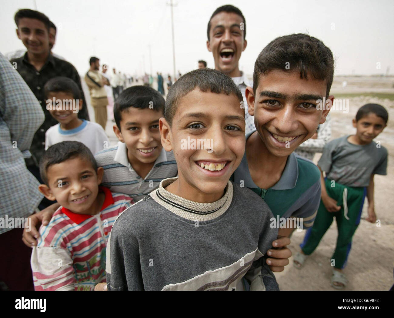 Local children smiling for journalists as coalition forces move into Basra to secure the city.PA Photo: Dan Chung/Guardian/MOD Pool. Stock Photo