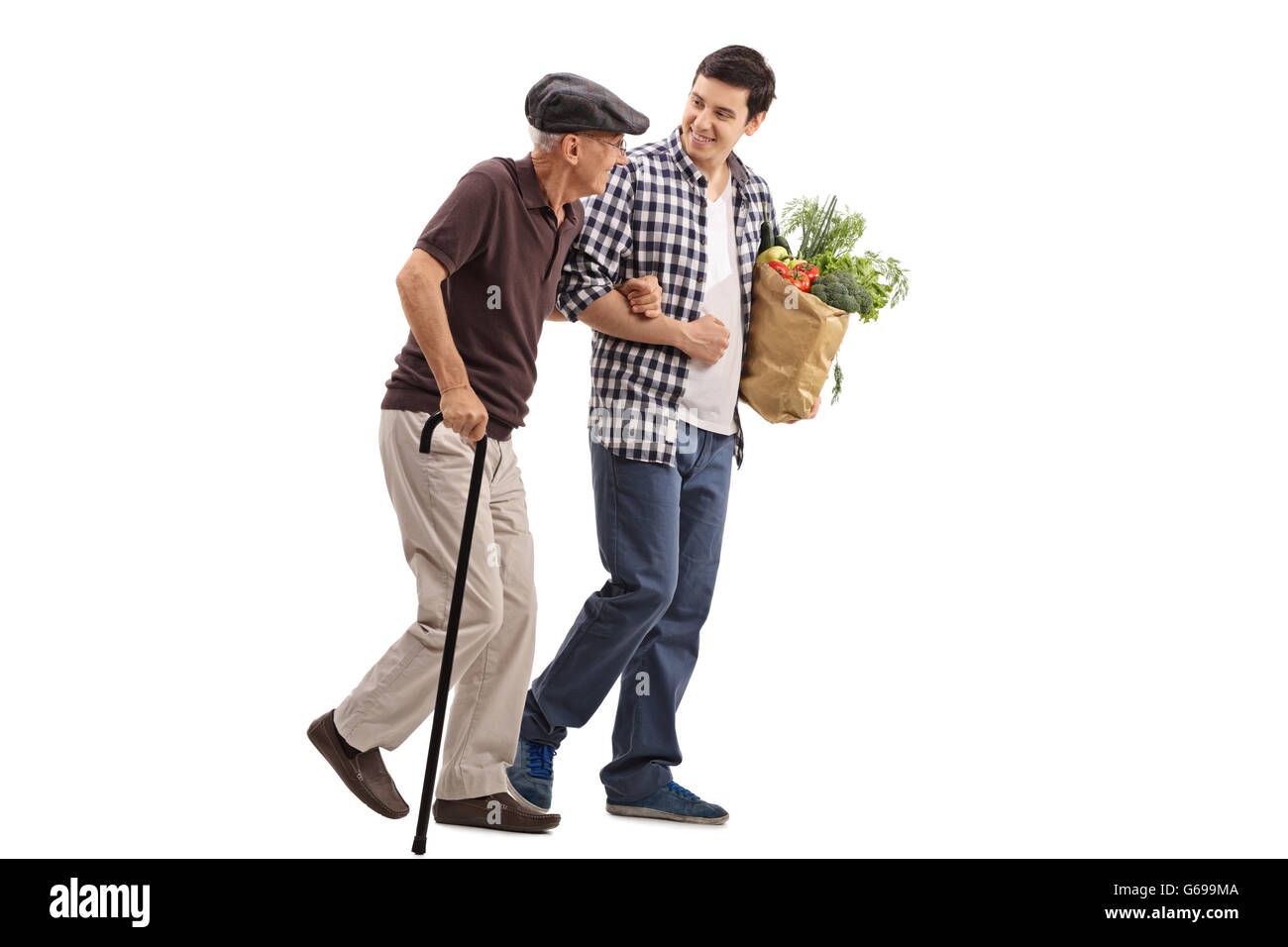 Kind young man helping a senior gentleman with his groceries isolated on white background Stock Photo