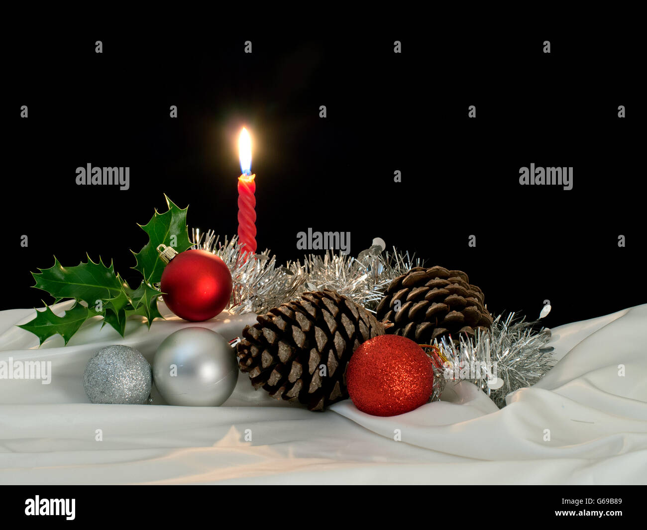 Traditional seasonal objects. Primarily lilt by candle light. Black background, copyspace. Stock Photo
