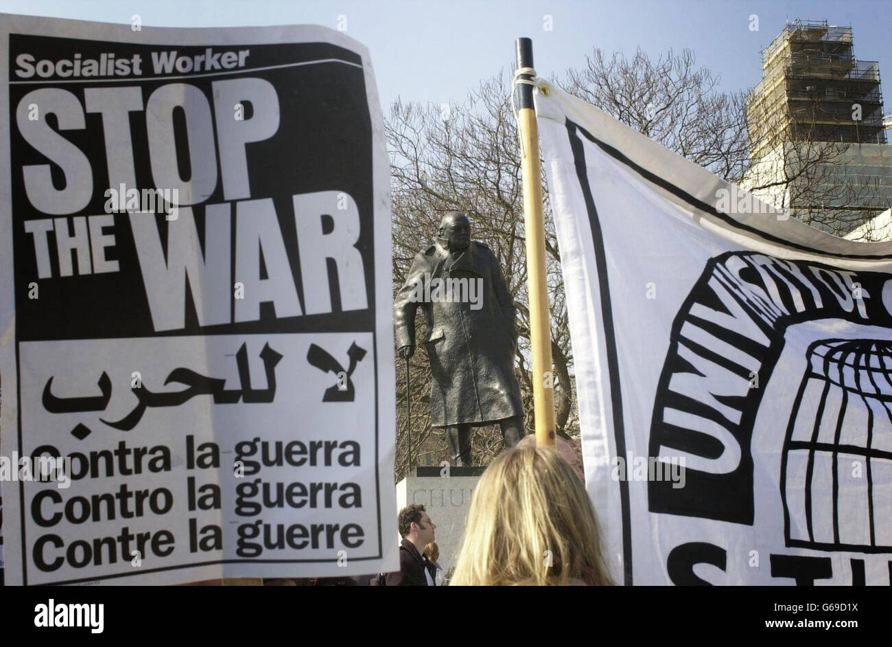 The statue of Winston Churchill watches over anti-war demonstrators in London's Parliament Square. War with Iraq was looking closer with the deadline for President Saddam Hussein to leave his country looming and reports that US troops had entered the demilitarised zone between Iraq and Kuwait. Stock Photo