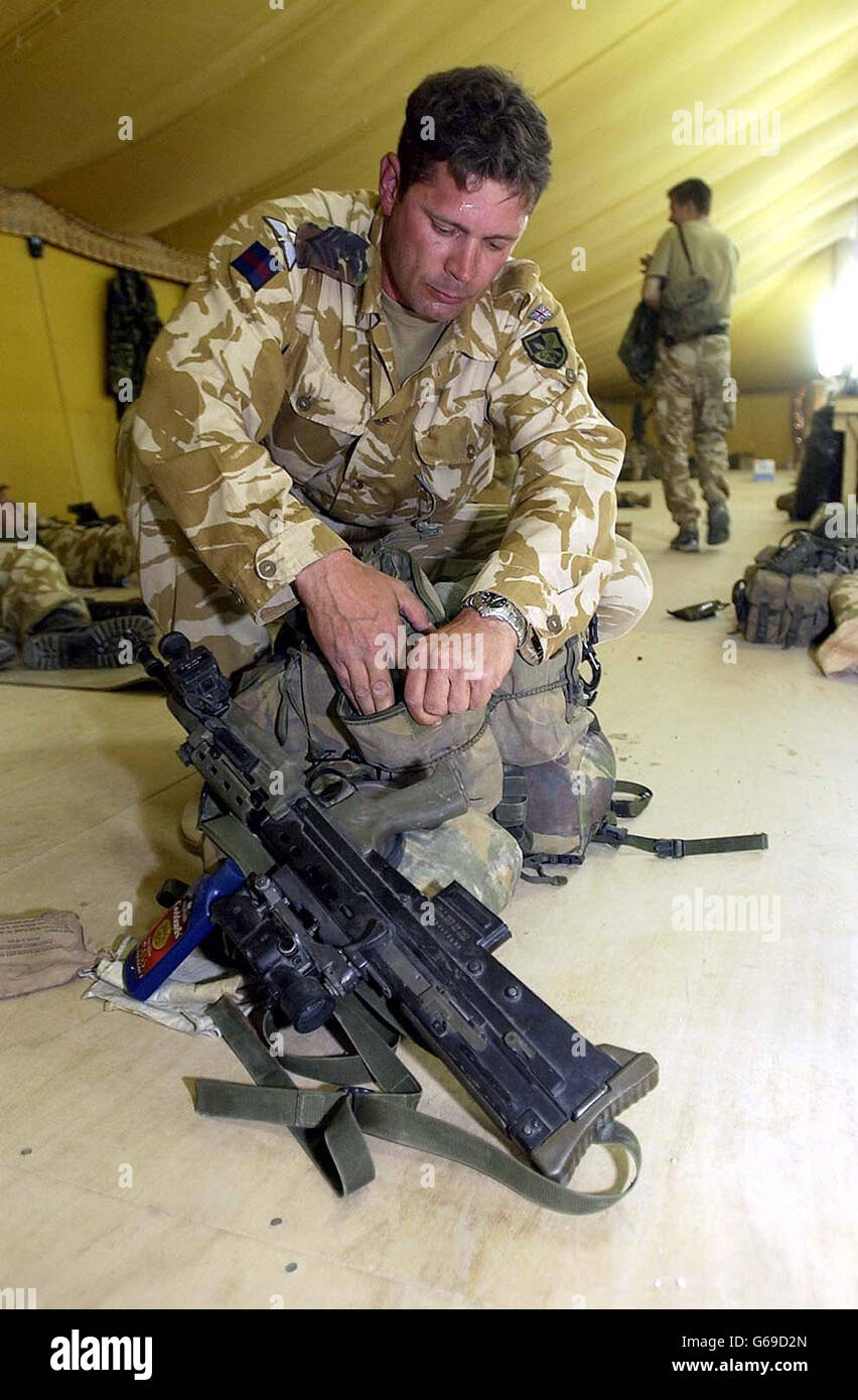 Corp. of Horse in D Squadron Household Cavalry regiment, David Simpson, packs his webbing in the Kuwaiti desert, as the prospect of war looms. Stock Photo