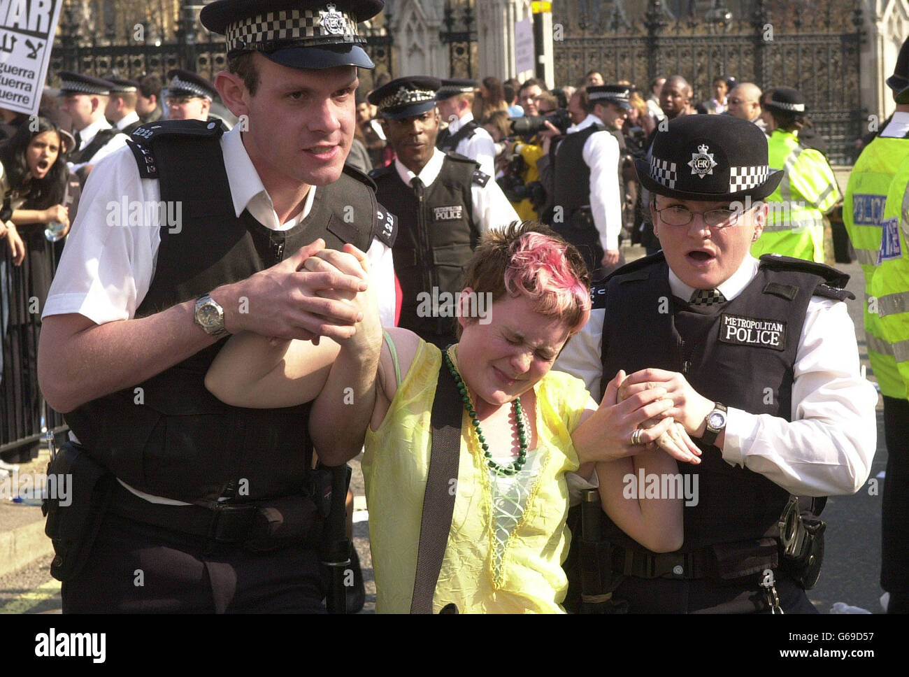 An anti-war protester is removed by police during a demonstration in Parliament Square, Westminster. War with Iraq is looking more likely amid reports that US troops had entered the demilitarised zone between Iraq and Kuwait. Stock Photo