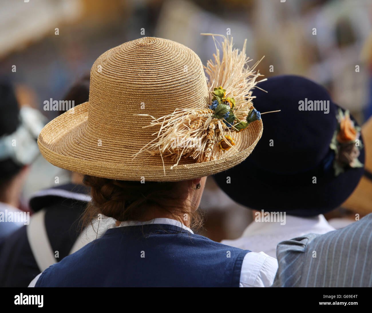 fashion woman with straw hat with ears of corn in a crowd Stock Photo