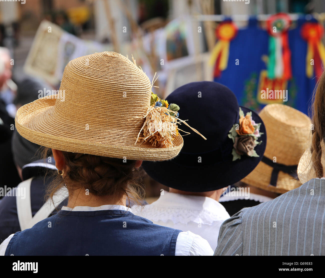 young woman with straw hat with ears of corn in a crowd Stock Photo