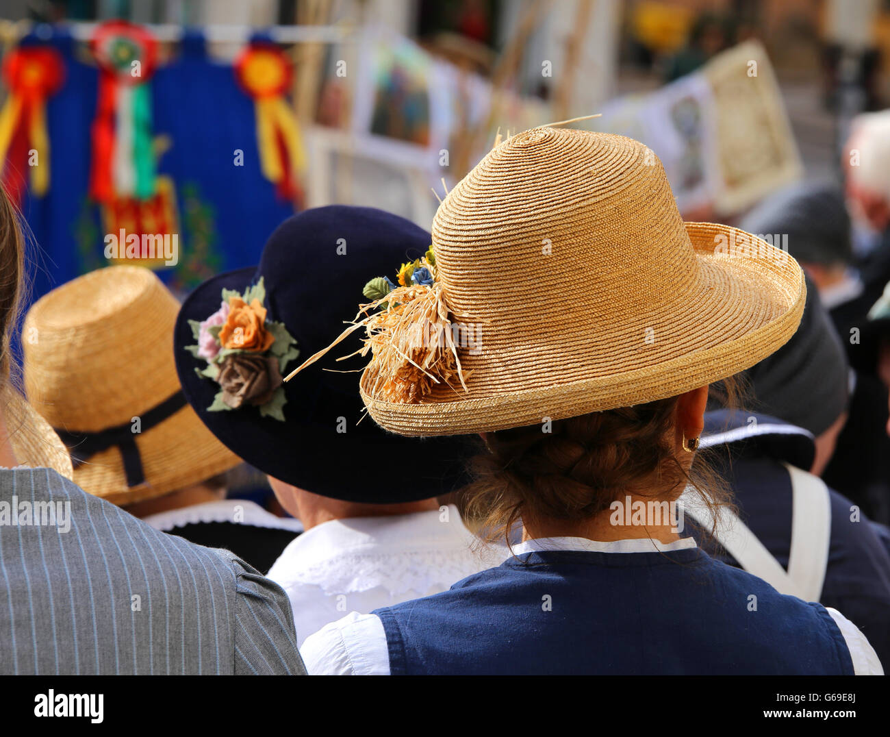 old woman with straw hat with ears of corn in a crowd Stock Photo