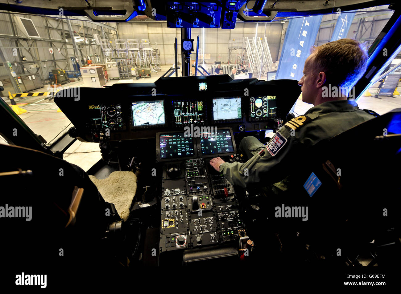 Aircrew use touch screen panels in the cockpit inside the Merlin Mk 2 aircraft, which is on display at Royal Naval Air Station Culdrose, Cornwall, to mark the first of the UK's fleet of next generation anti-submarine maritime patrol Merlin helicopters being handed over to the Royal Navy. Stock Photo