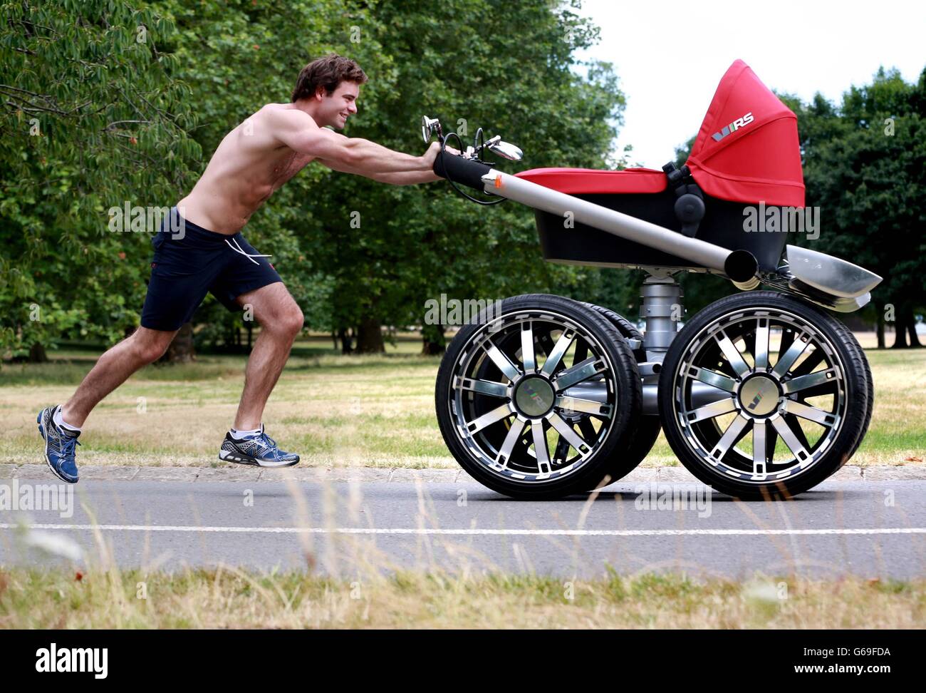 Nicholas Richardson pushes the 'vRS Mega Man-Pram', which features in the  new SKODA Octavia vRS YouTube advert, through London's Hyde Park ahead of  the UK launch for the car on August 1st