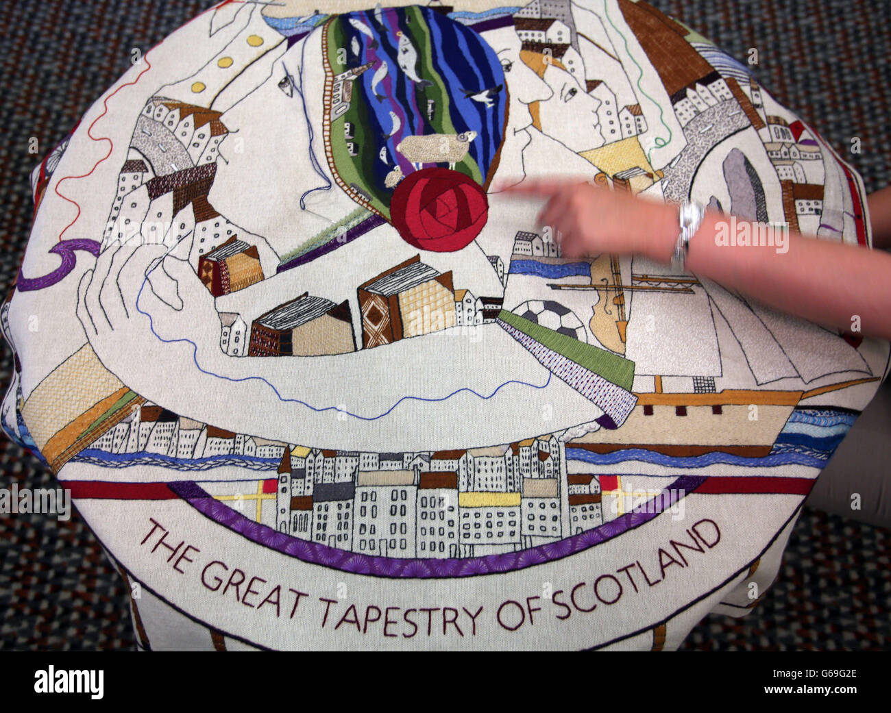 Holyrood's Presiding Officer Tricia Marwick sews the final stitch on the world's longest tapestry which will go on display at the Scottish Parliament in September. Stock Photo