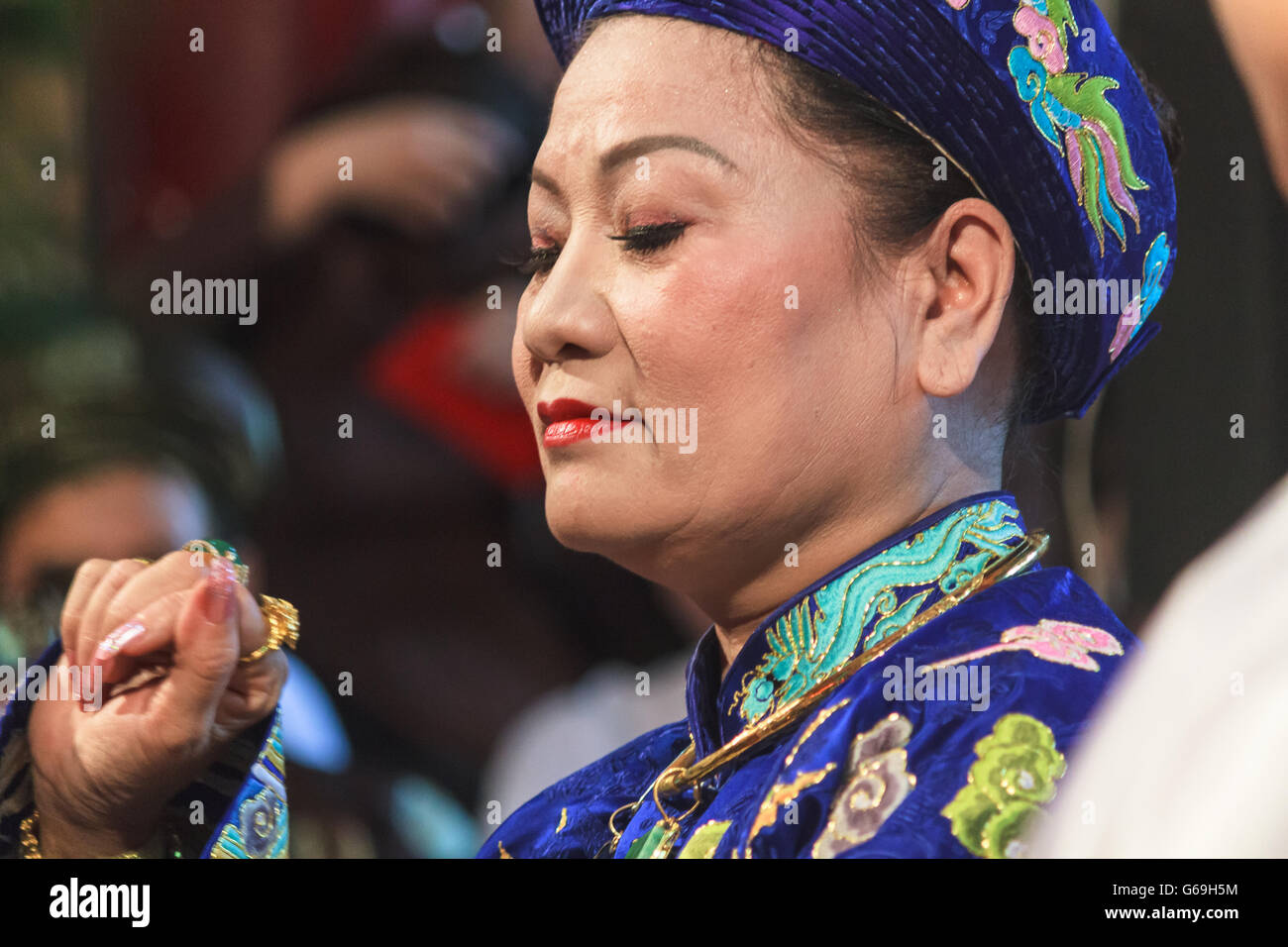 A female medium is dressed up and about to perform Len Dong, a spirit mediumship ritual in Central Vietnam. Stock Photo