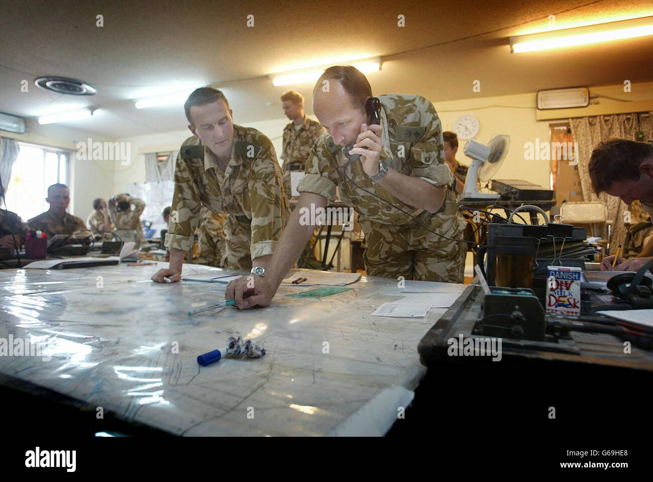 Chief of Staff Lt.Col Richard Watts keeps up to date with the battle's progress inside the Command Post at the Headquarters of 3 Commando Brigade, Umm Qsar, as 40 Commando attack an Iraqi held position. Stock Photo