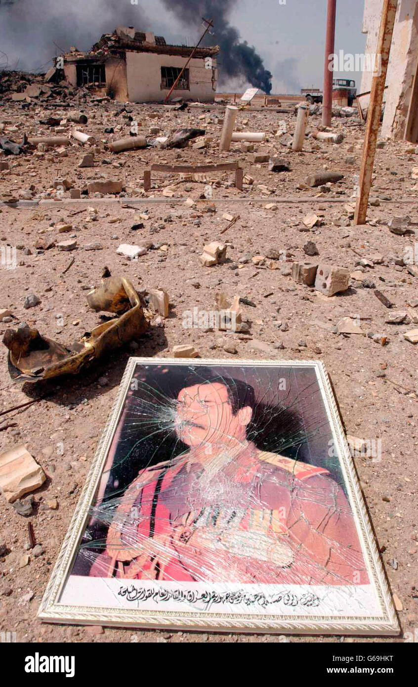 A portrait of Iraq's leader Saddam Hussein lies amongst the debris of an Iraqi base, southern Iraq. Stock Photo