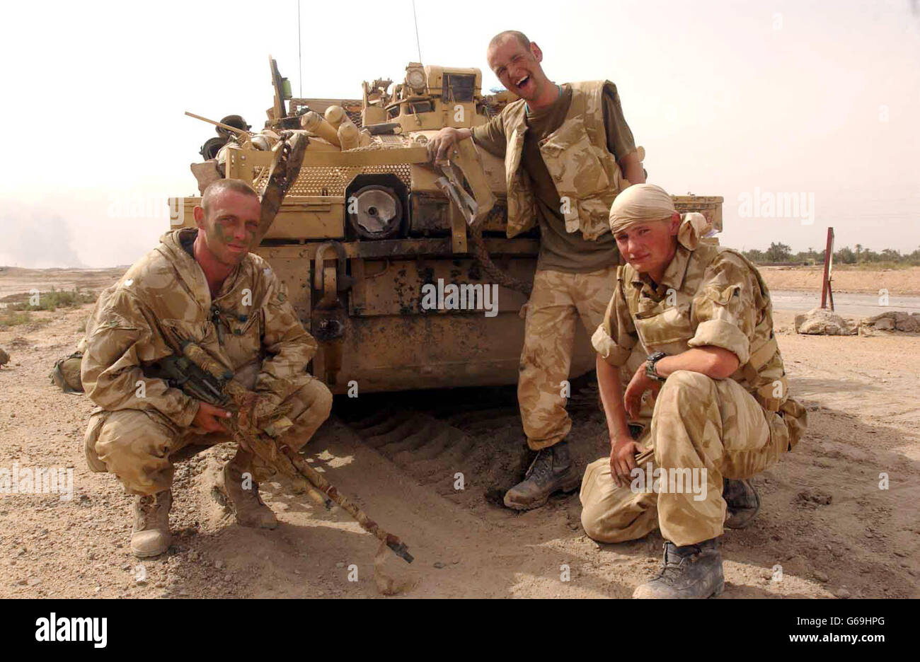 Picture made available Monday March 31st 2003, of (left-right) Pritch, Danny and Blackie in Southern Iraq, with their vehicle which was put out of action by a rocket propelled grenade. Stock Photo