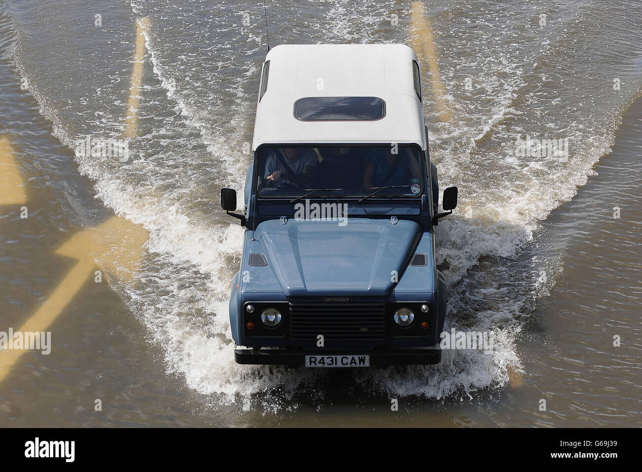 A motorist makes his way through flood water on Mountsorrel Lane in Loughborough. Torrential rain, thunder and lightning is blighting the first weekend of the school holidays, as thousands set off across the UK for their summer break. Stock Photo