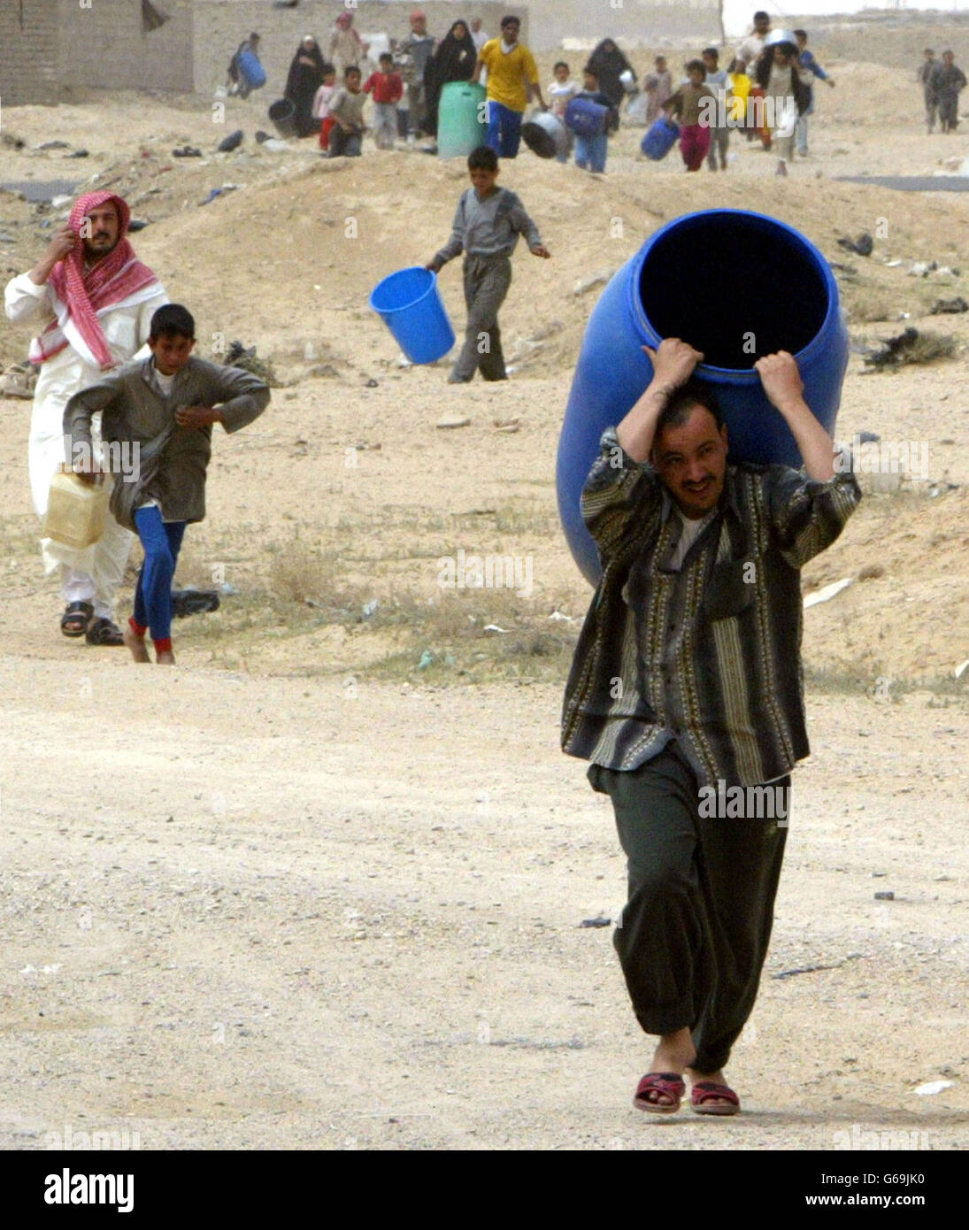 Iraqi people take containers for water Stock Photo