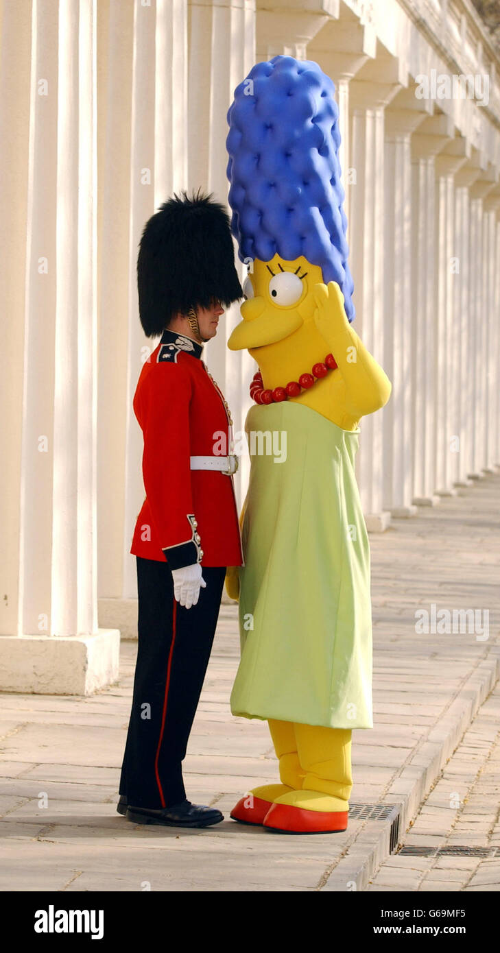 Marge Simpson, poses with a 'guardsman' during a photocall outside Buckingham Palace, London, to celebrate the 300th episode of The Simpsons. Stock Photo