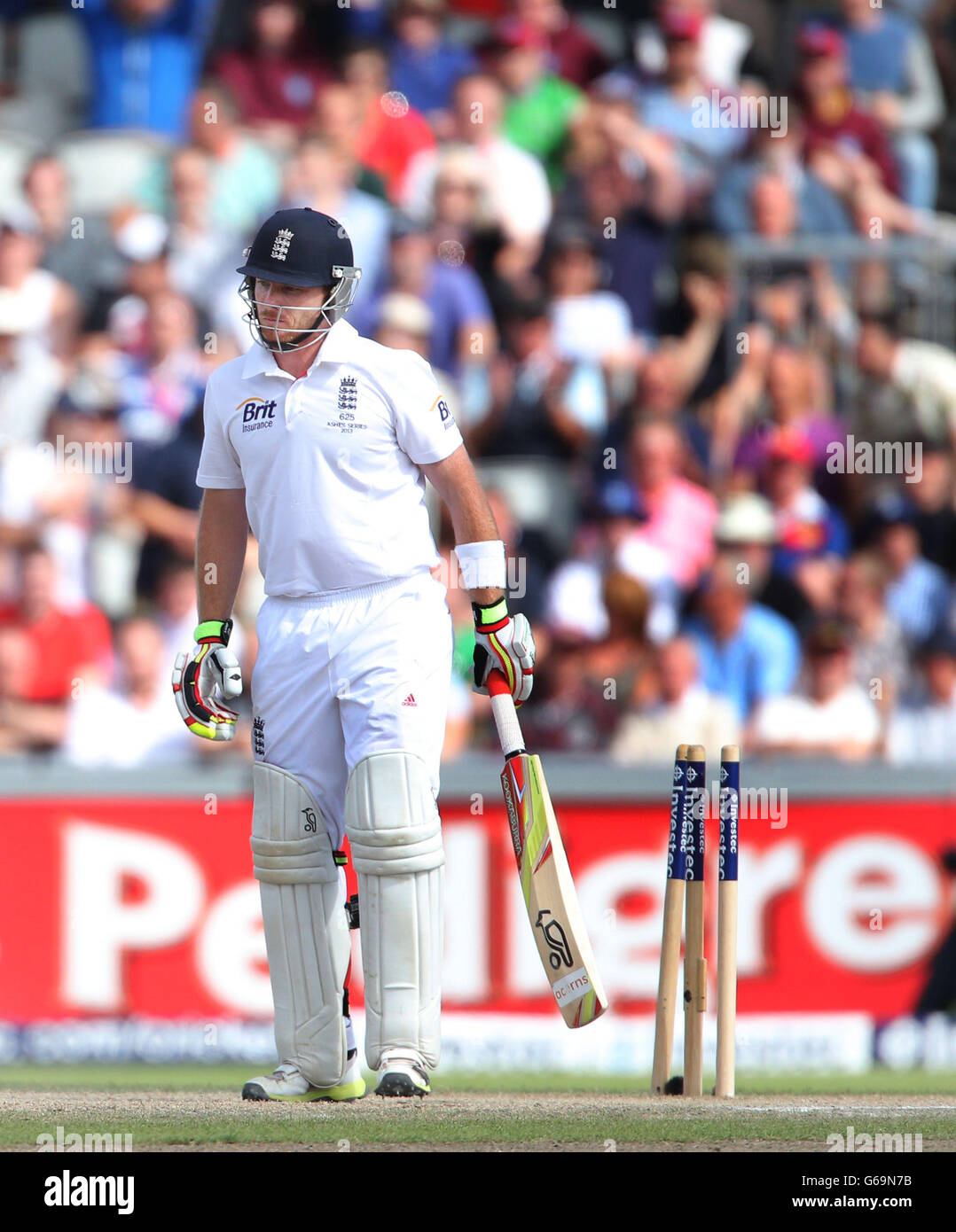 England's Ian Bell shows his dejection after he was cleaned bowled for 60 by Australia's Ryan Harris during day three of the Third Investec Ashes test match at Old Trafford Cricket Ground, Manchester. Stock Photo