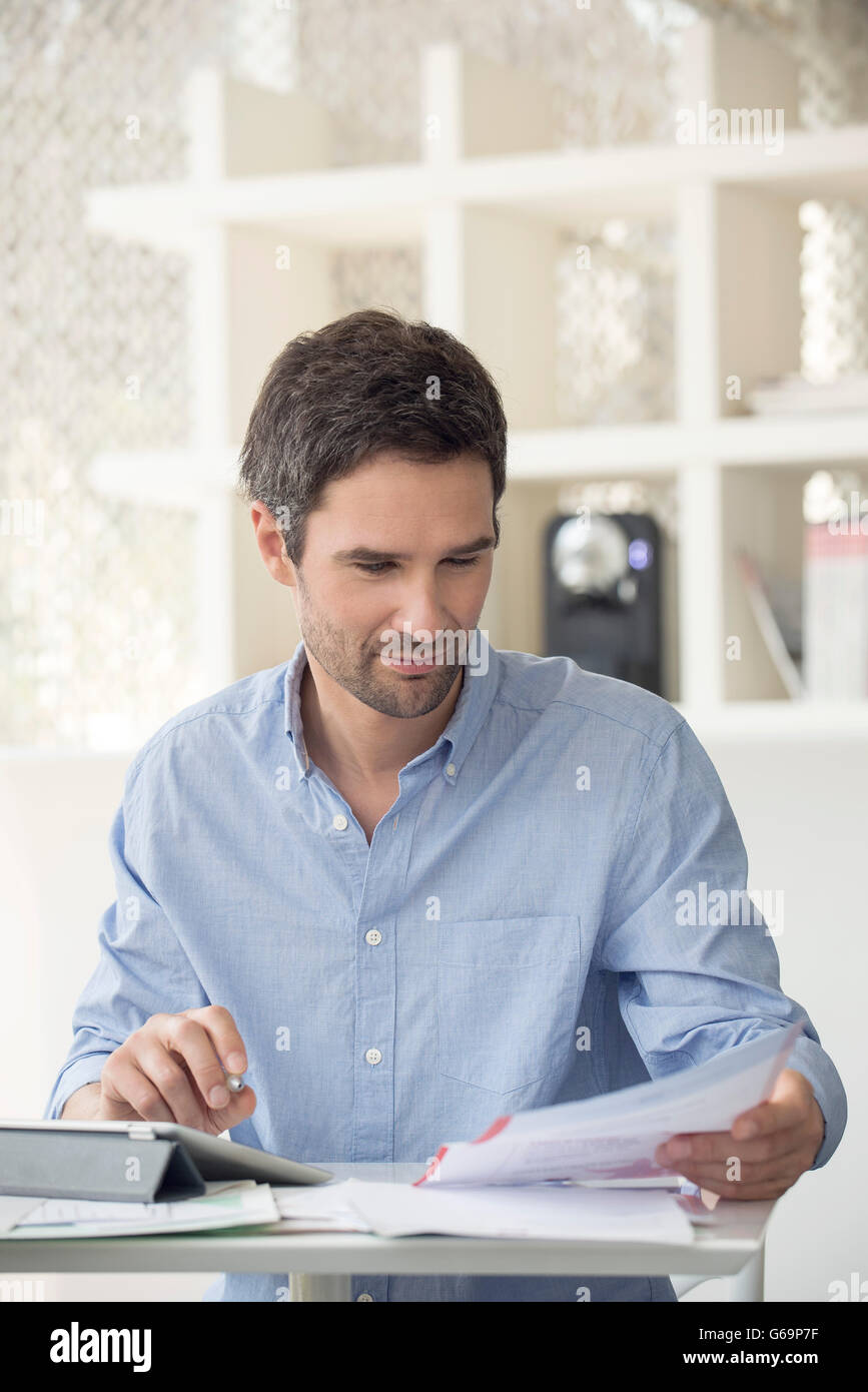 Man using online banking to manage personal finances Stock Photo