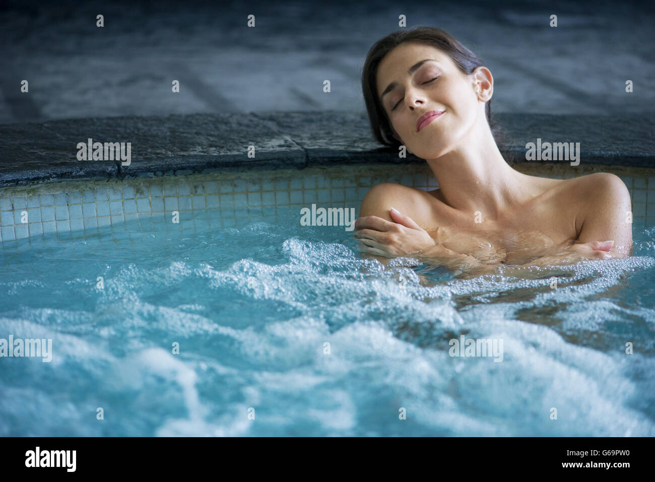 Woman In Jacuzzi Woman relaxing in jacuzzi Stock Photo - Alamy