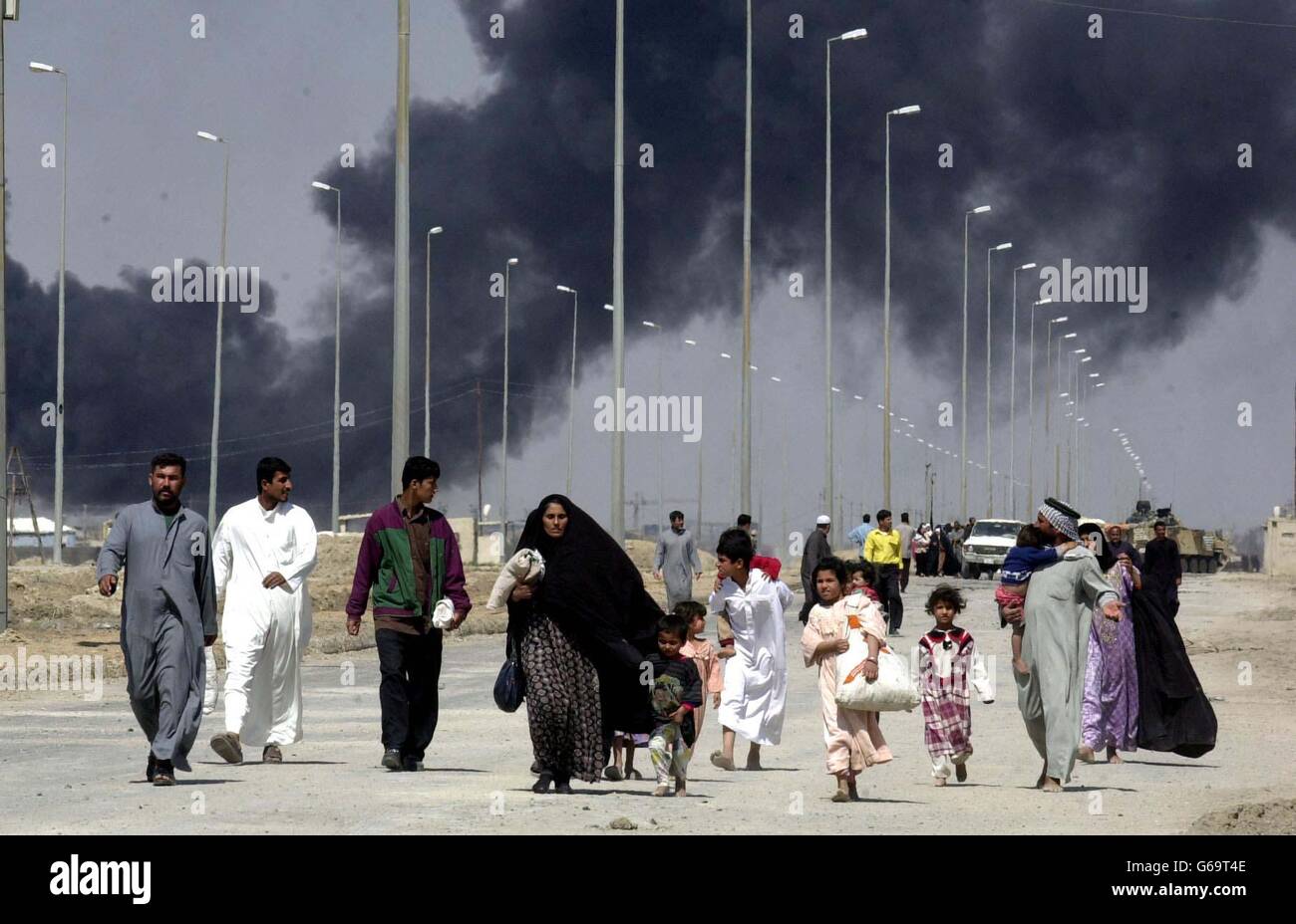 Iraqis Flee Basra. Locals flee the burning town of Basra in Iraq. Stock Photo