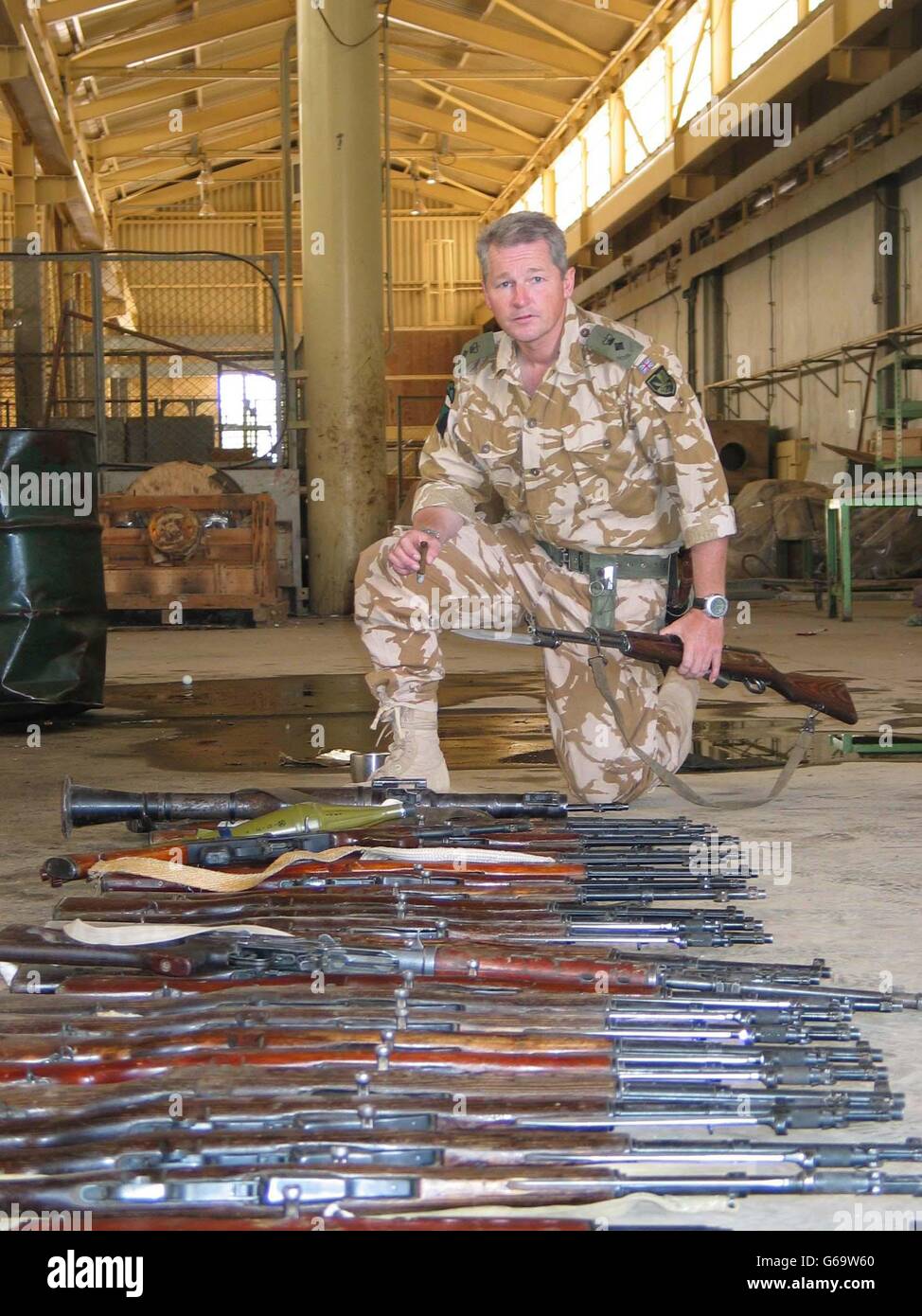 Lt Col Tim Collins with weapons confiscated from Ba'ath activists, with which he intends to re-arm a new police force. Stock Photo