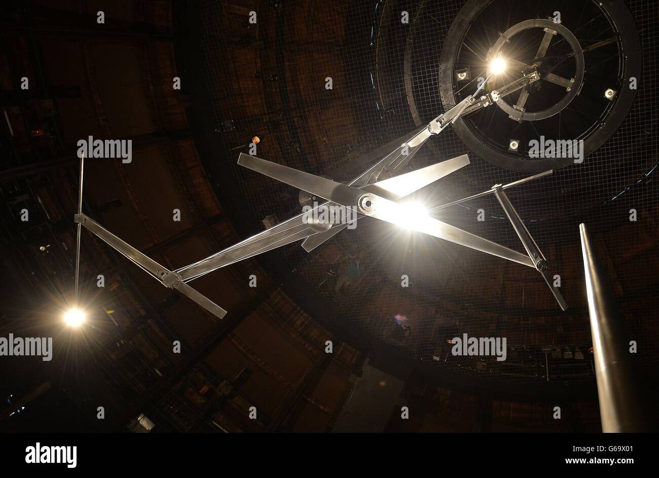 The work of British Artist Conrad Shawcross titled 'Timepiece', which is three revolving hands with lights at each end to replicate Clock hands, at a press preview at The Rounhouse , in north London, where the modern art will be on display for a month. Stock Photo