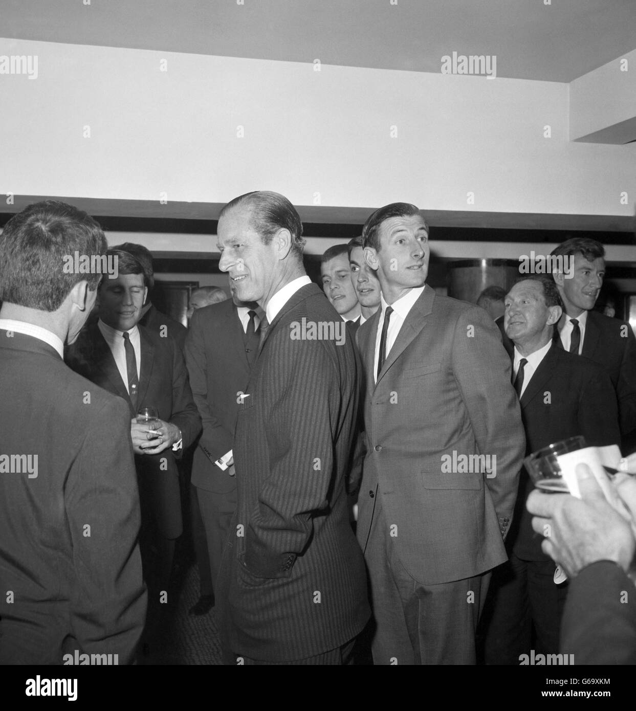 Prince Philip, The Duke of Edinburgh talking with members of the Australian cricket touring team, at the Savoy Hotel, London, where a luncheon was being given for them by the British Sportsmen's Club, of which Duke is President. Extreme right is Bill Lawry, the Australians' captain Stock Photo