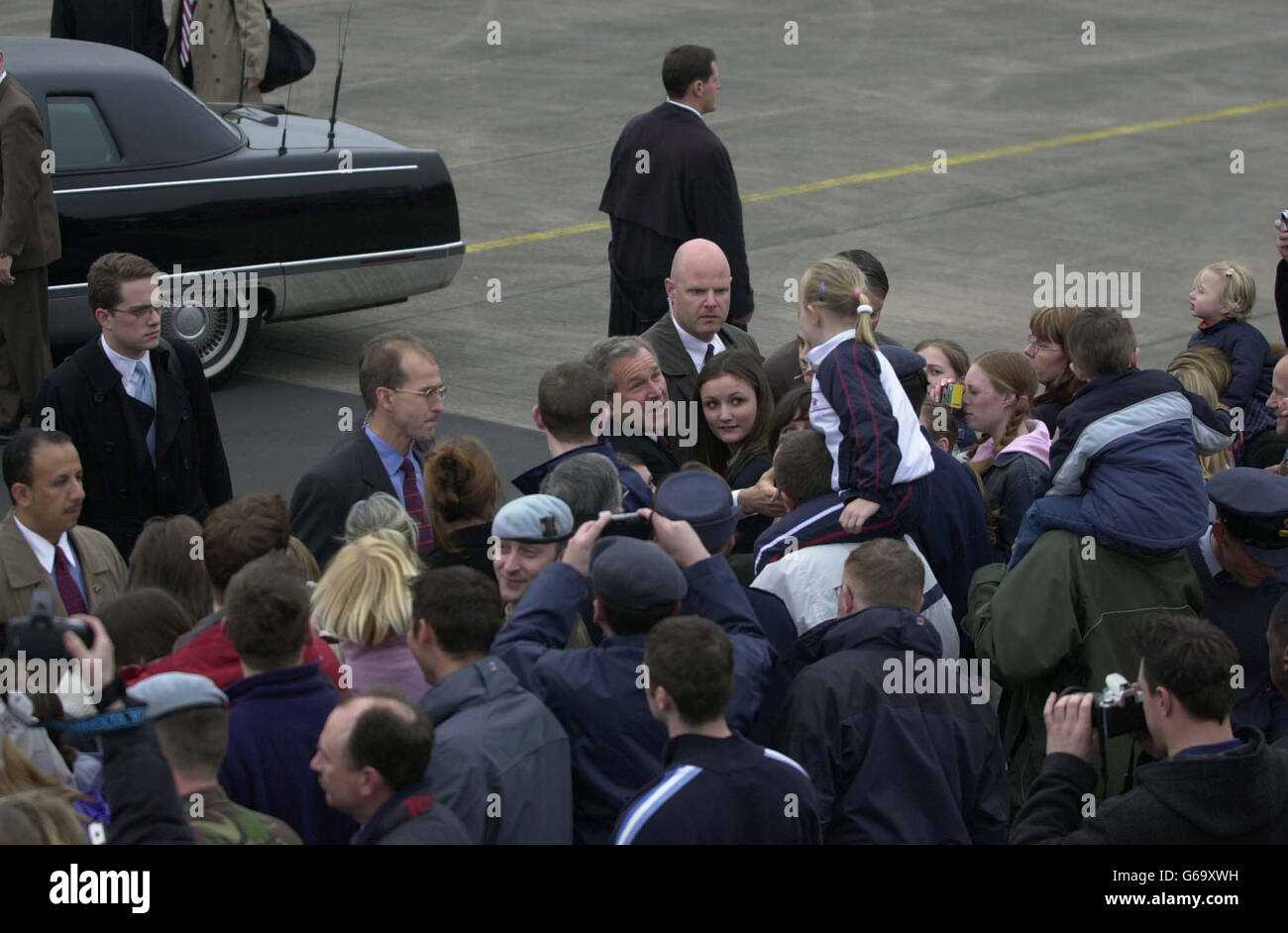 US President George W Bush is greeted by some of the families working at RAF Aldergrove, in Northern Ireland, where he touched down in Airforce One. * Mr Bush continued by Black Hawk helicopter from the base to Hillsborough Castle, outside Belfast, for talks on the war in Iraq with British Prime Minister Tony Blair. Mr Bush was also expected to use the visit to urge politicians and paramilitaries in Northern Ireland to go the extra mile for peace. Stock Photo