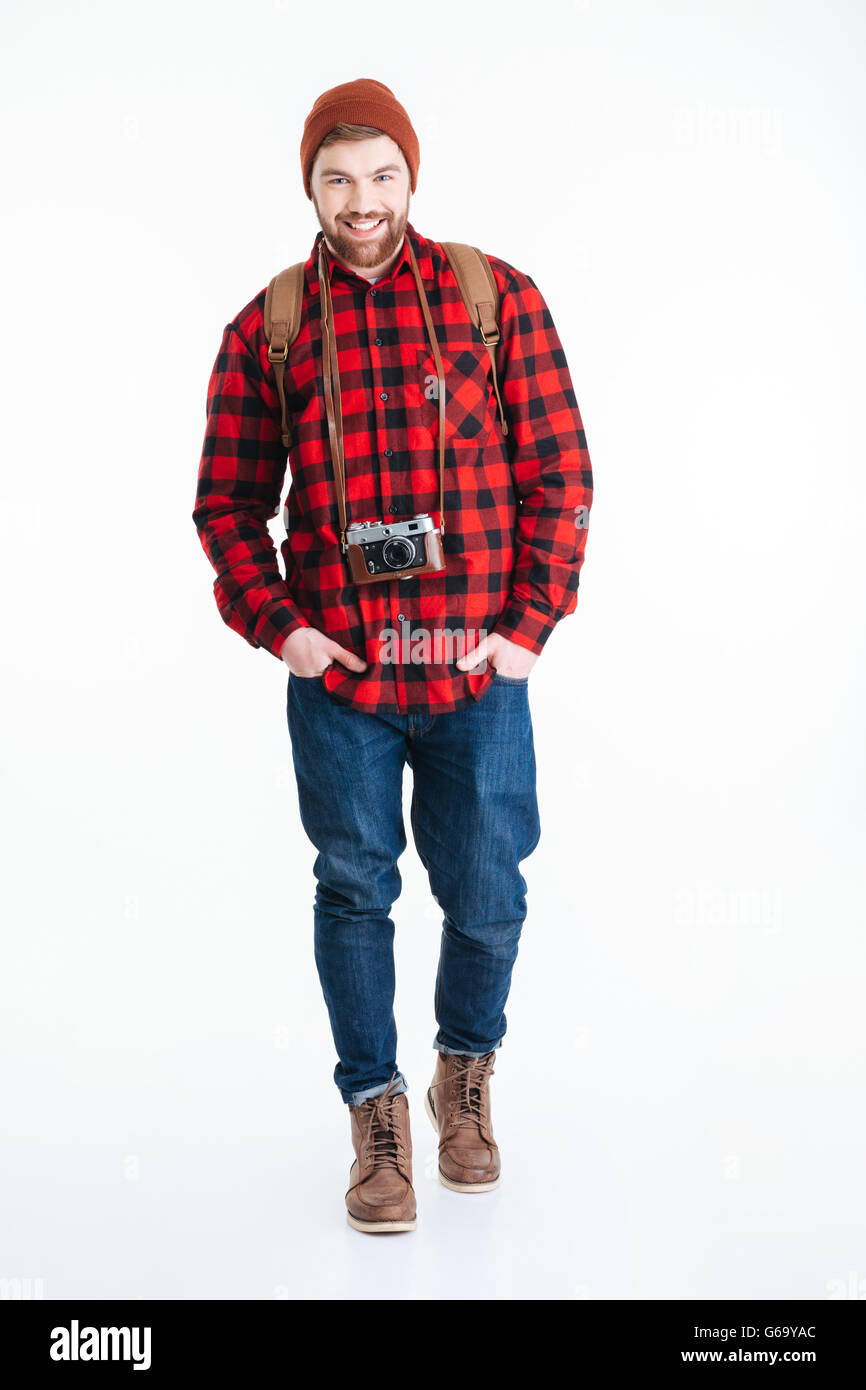 Full length portrait of smiling male tourist looking at camera isolated ...