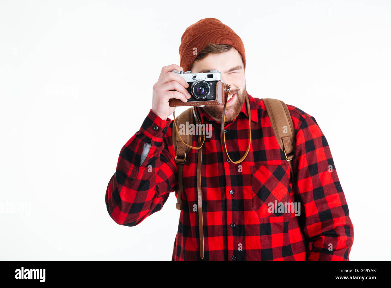 Happy casual man making photo on camera isolated on a white background ...
