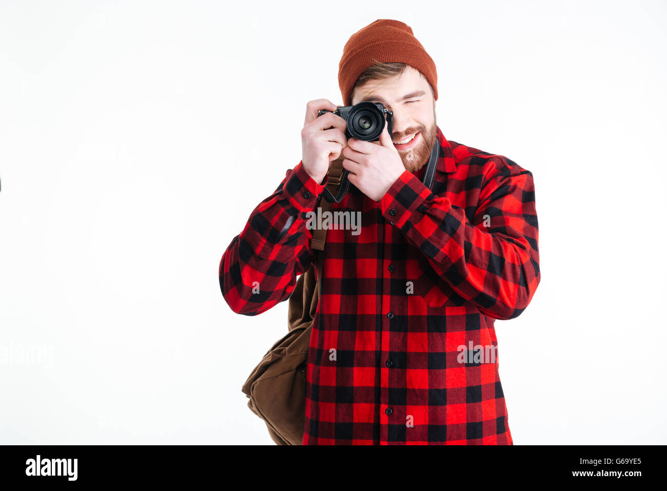 Happy casual man making photo on camera isolated on a white background ...