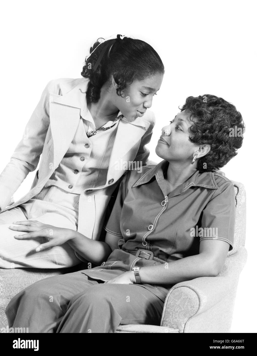 1970s AFRICAN-AMERICAN MOTHER DAUGHTER SMILING AT EACH OTHER PORTRAIT Stock Photo