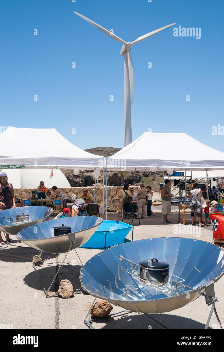 Cooking with a parabolic solar reflector at the Eolica festival of renewable energy on Tenerife. Stock Photo