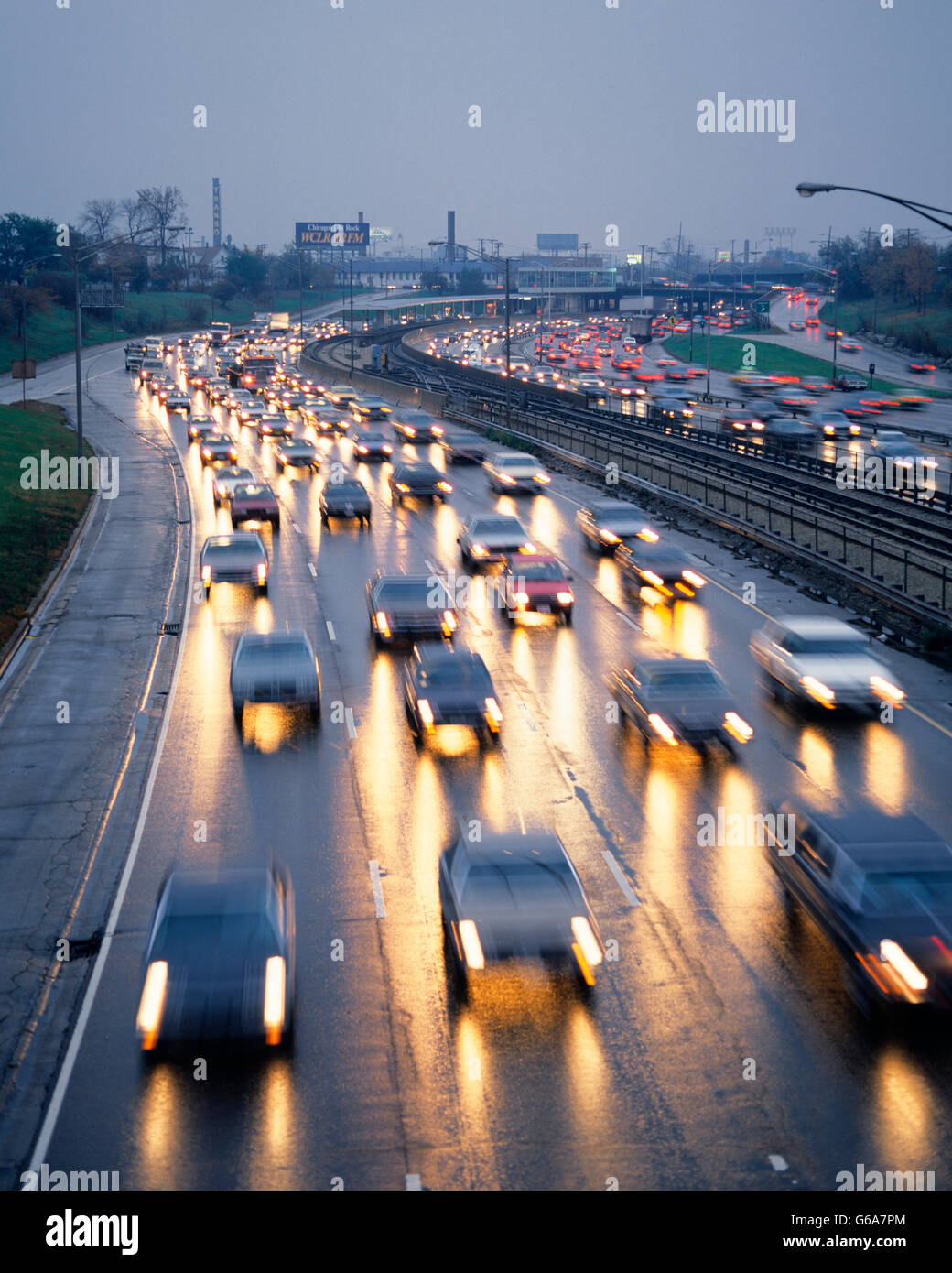 1980s TRAFFIC AT DUSK ON KENNEDY EXPRESSWAY CHICAGO ILLINOIS Stock