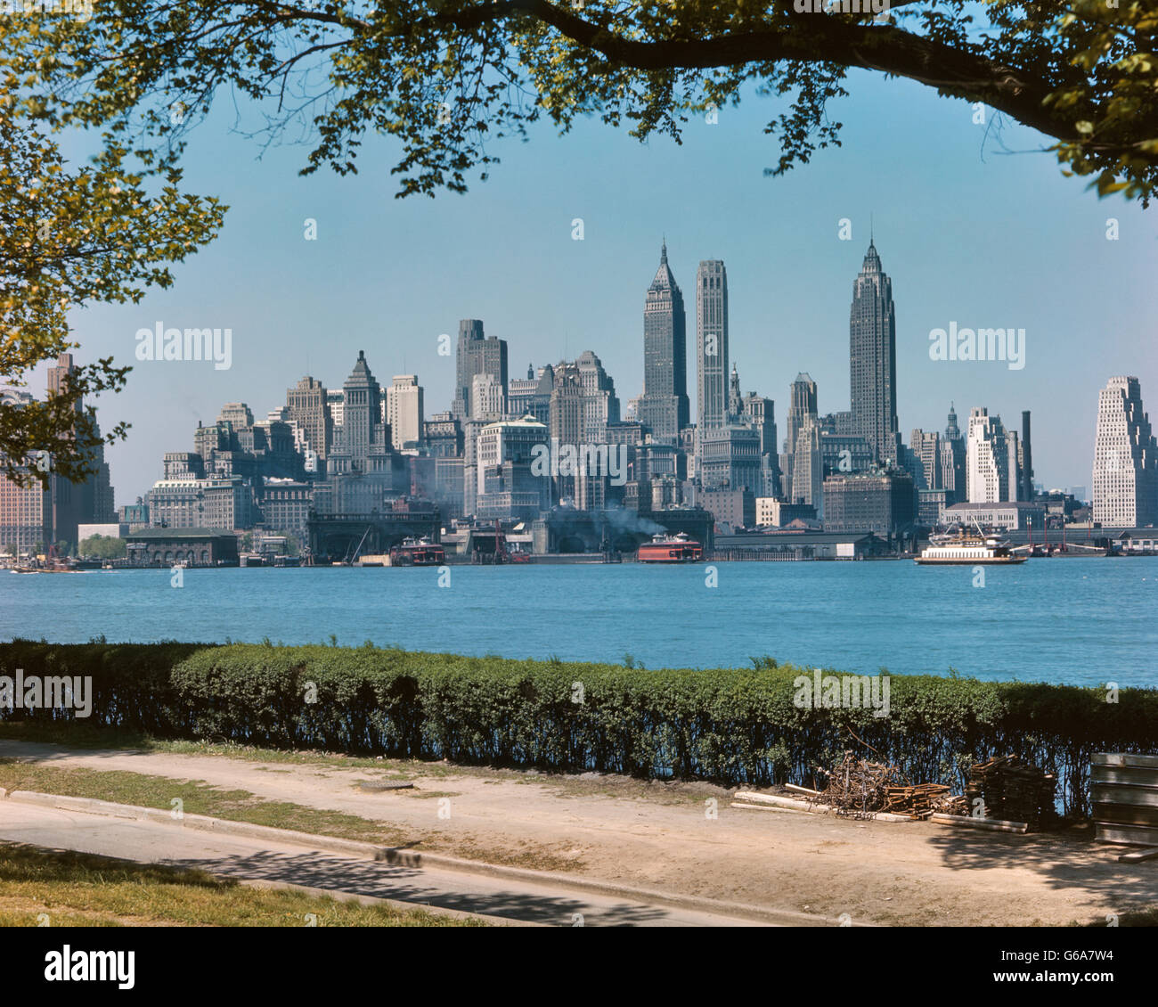 1950s SKYLINE OF DOWNTOWN MANHATTAN FROM GOVERNORS ISLAND IN THE HARBOR NYC USA Stock Photo