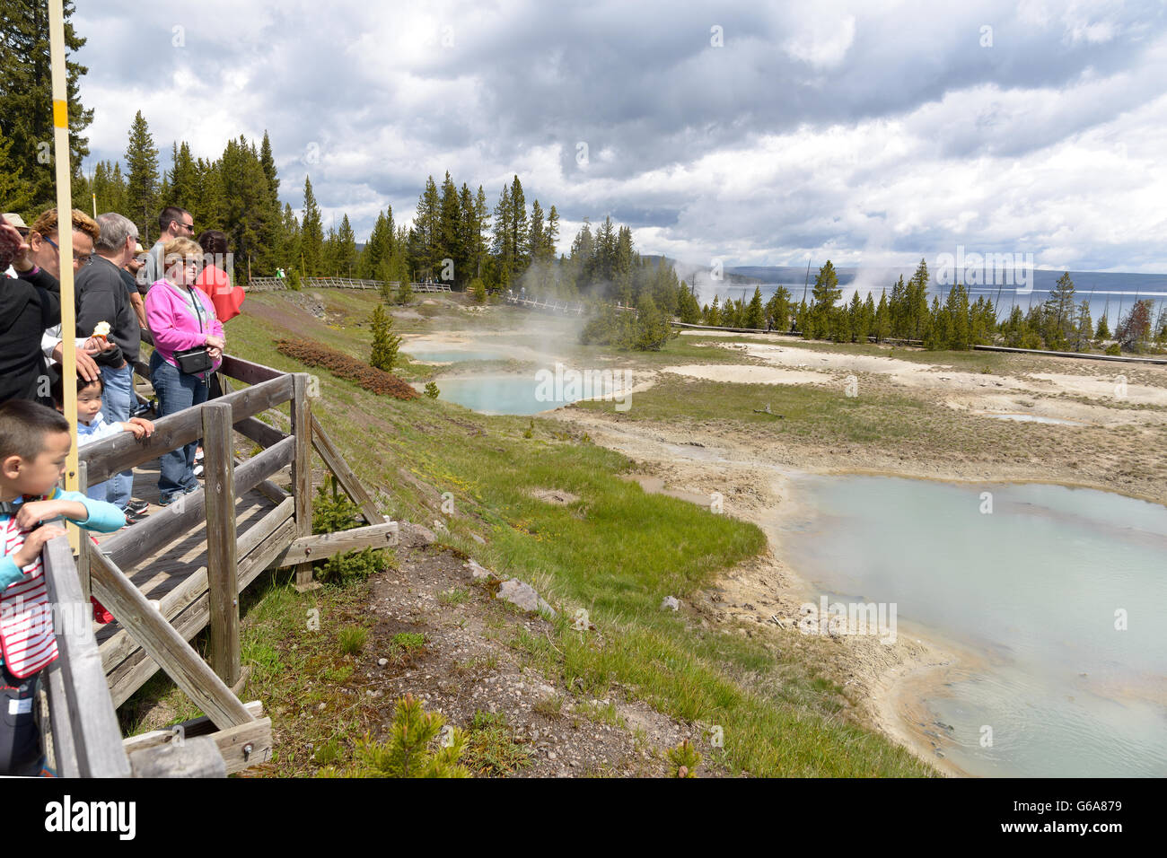 Clear, aqua hot spring with deep central hole, steam and limy shoreline